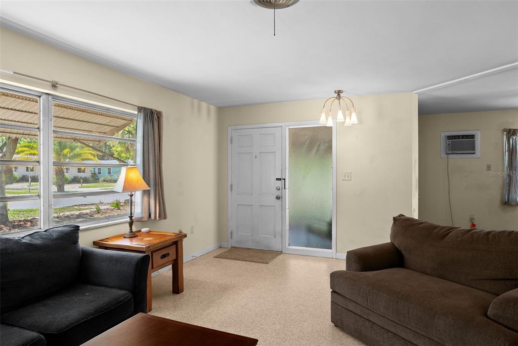 300 President Street Dunedin, FL 34698 - Photo 33 of 53 a living room with furniture and a large window