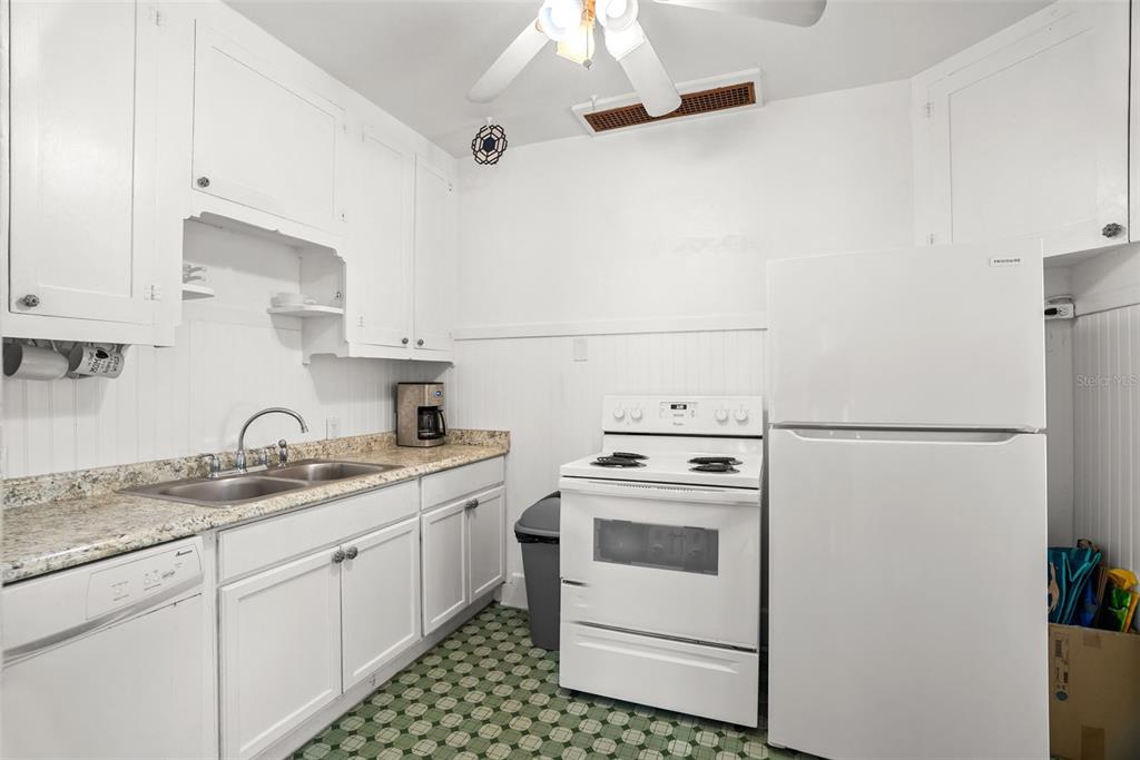 300 President Street Dunedin, FL 34698 - Photo 35 of 53 a kitchen with a sink stove and refrigerator
