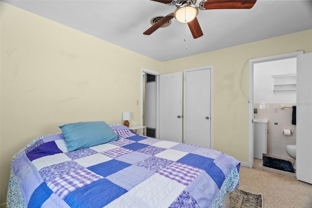 300 President Street Dunedin, FL 34698 - Photo 40 of 53 a bedroom with a bed and cabinets