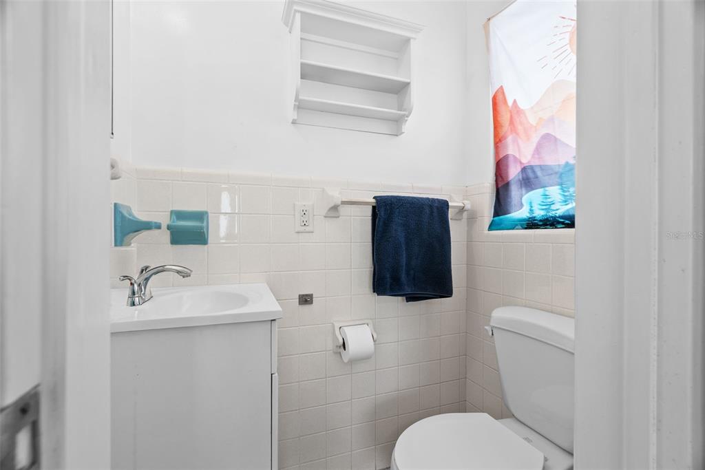 300 President Street Dunedin, FL 34698 - Photo 41 of 53 a bathroom with a toilet sink and mirror