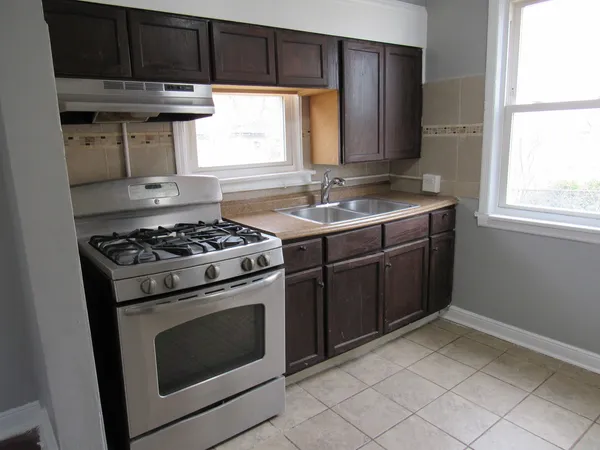 a kitchen with stainless steel appliances a stove a sink and a microwave
