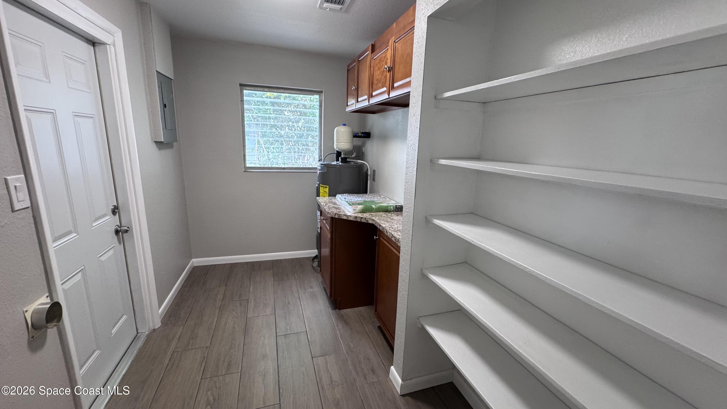 2137 Laden Road Melbourne, FL 32935 - Photo 20 of 23 a view of walk in closet with clothes and shoes