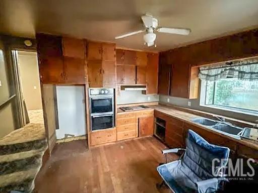 Undisclosed Address Ravendale, CA 96123 - Photo 2 of 9 a kitchen with stainless steel appliances granite countertop a refrigerator a sink dishwasher a stove and white countertops with wooden floor