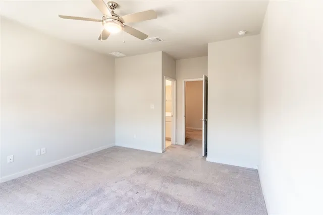 a bathroom with a granite countertop sink a toilet and shower