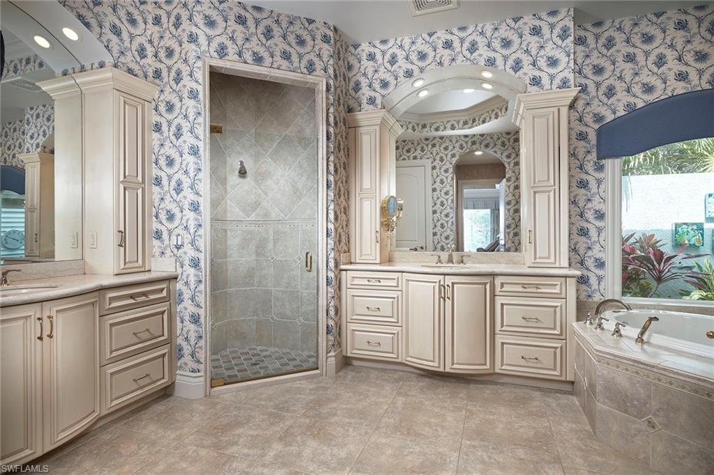 1626 Chinaberry Way Naples, FL 34105 - Photo 14 of 35 view of a bathroom with a sink a large mirror and a bathtub