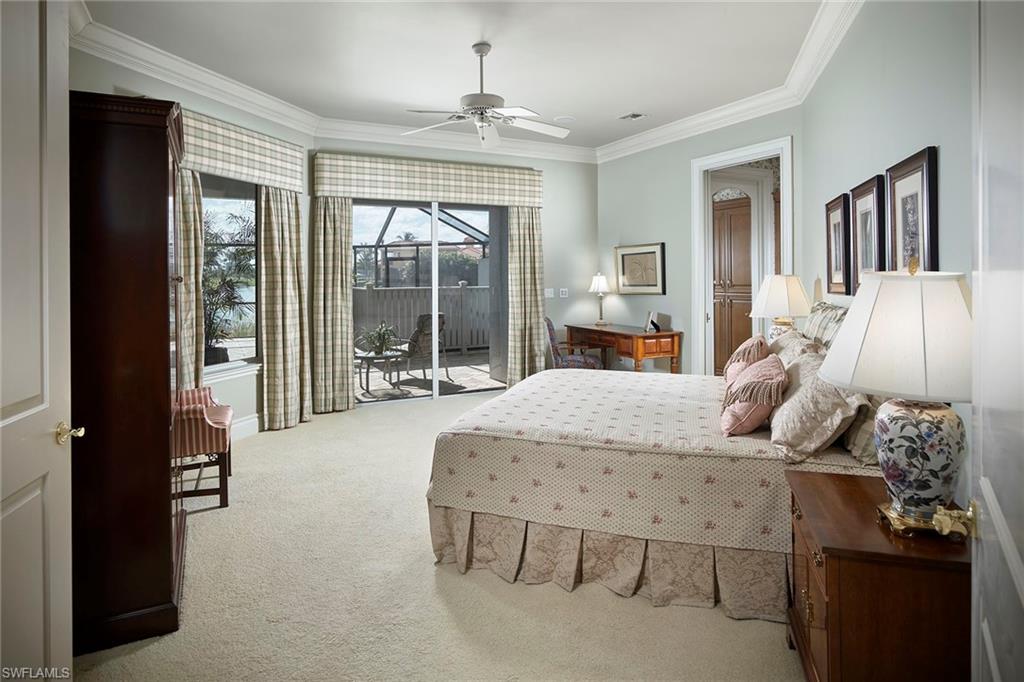 1626 Chinaberry Way Naples, FL 34105 - Photo 15 of 35 a bedroom with furniture and large windows