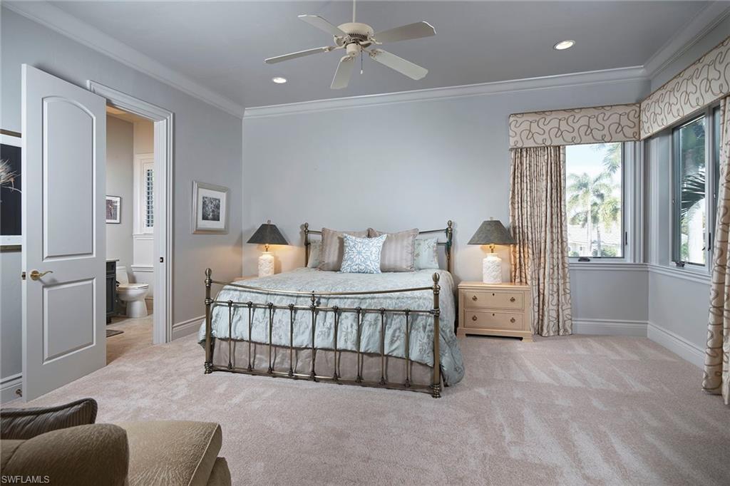1626 Chinaberry Way Naples, FL 34105 - Photo 17 of 35 a bedroom with bed and window