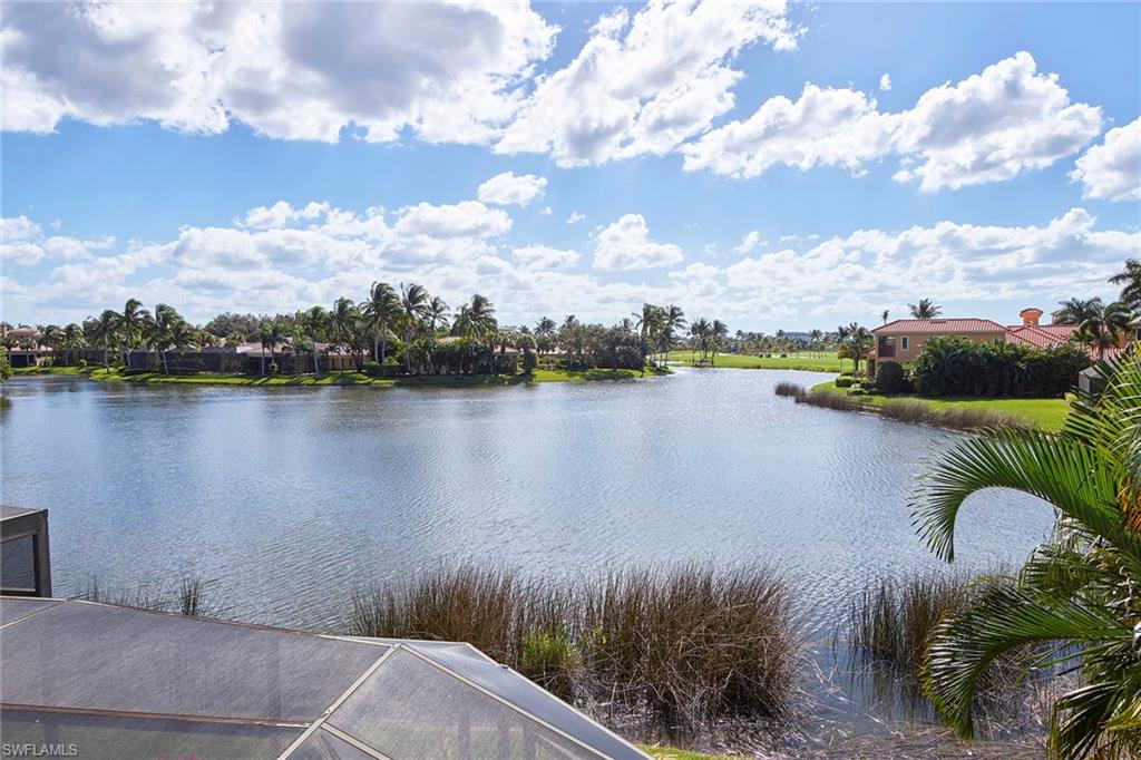 1626 Chinaberry Way Naples, FL 34105 - Photo 22 of 35 a view of a lake with houses in the back