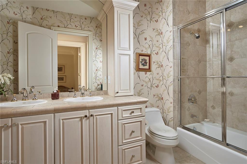 1626 Chinaberry Way Naples, FL 34105 - Photo 24 of 35 a bathroom with a granite countertop toilet sink and a shower