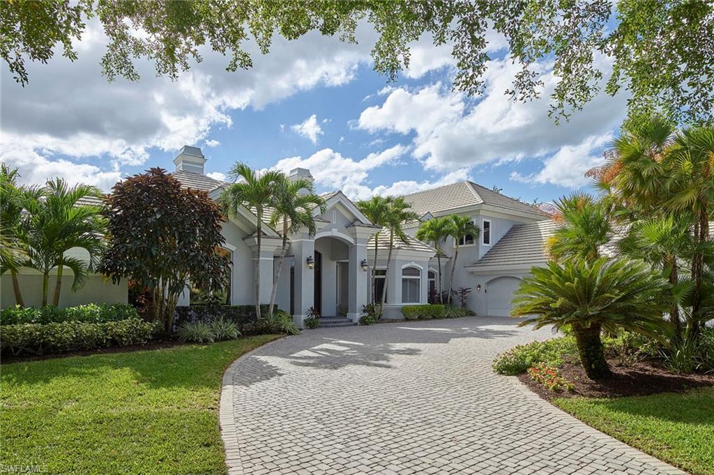 1626 Chinaberry Way Naples, FL 34105 - Photo 29 of 35 a front view of a house with garden and trees