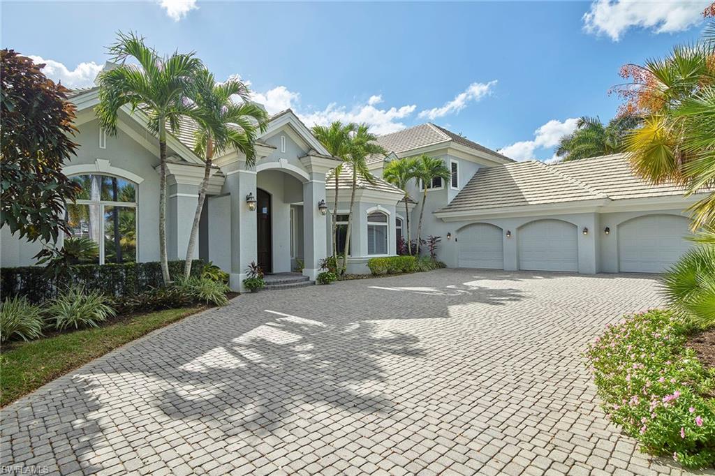 1626 Chinaberry Way Naples, FL 34105 - Photo 30 of 35 a front view of a house with a garden