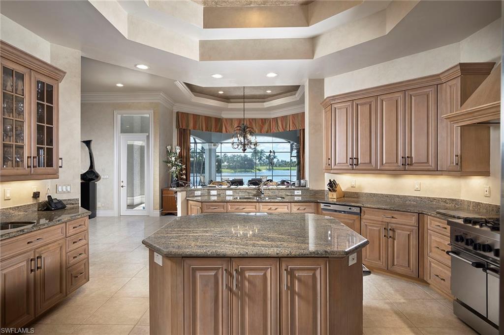 1626 Chinaberry Way Naples, FL 34105 - Photo 9 of 35 a kitchen with a sink stove top oven and cabinets