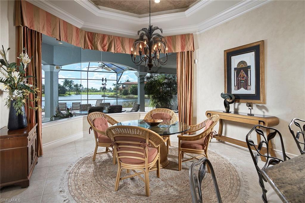 1626 Chinaberry Way Naples, FL 34105 - Photo 10 of 35 a dining room with furniture a chandelier and window