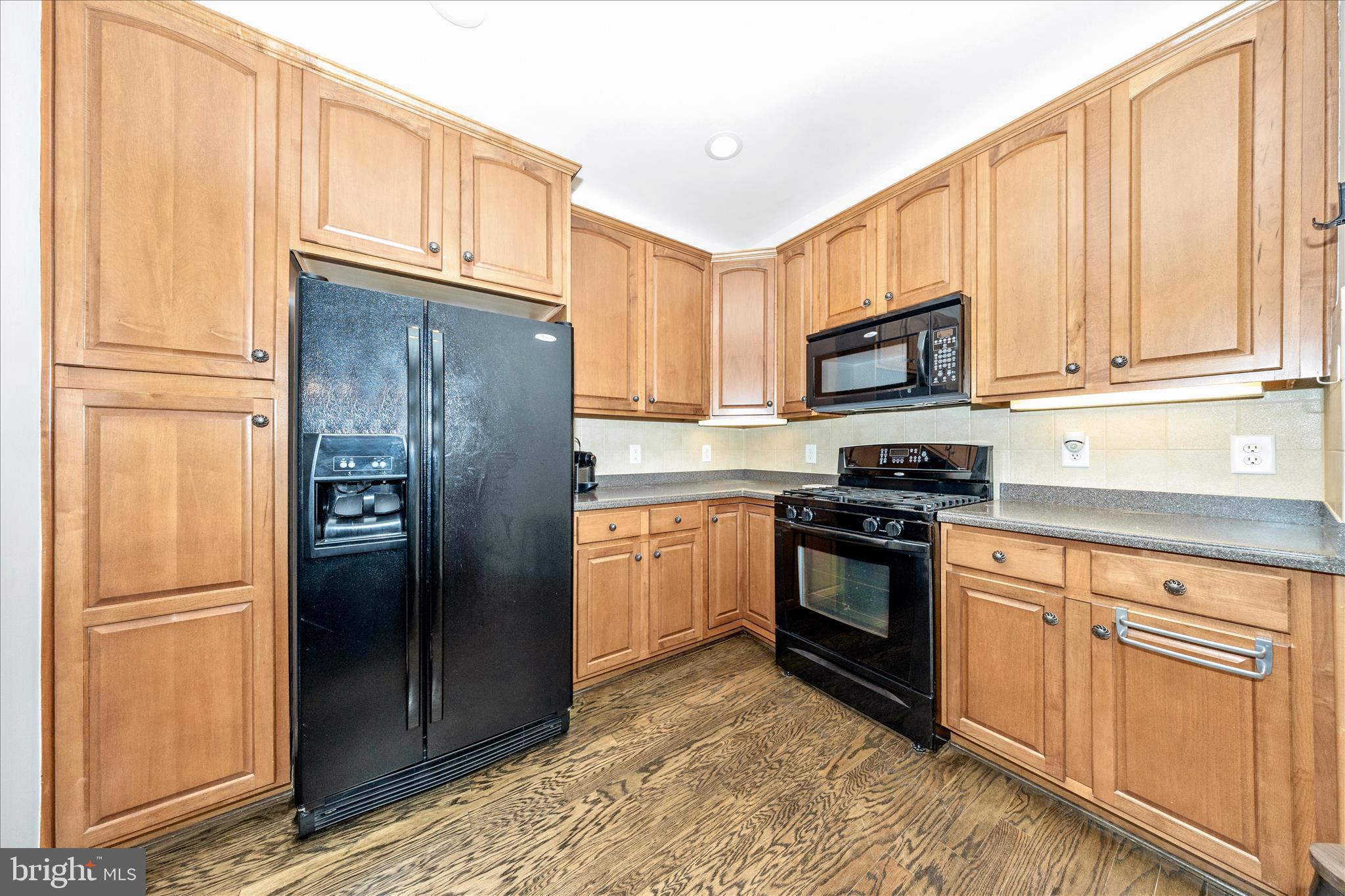 35 East All Saints Street, Unit 114 Frederick, MD 21701 - Photo 14 of 37 a kitchen with stainless steel appliances granite countertop a refrigerator stove and cabinets