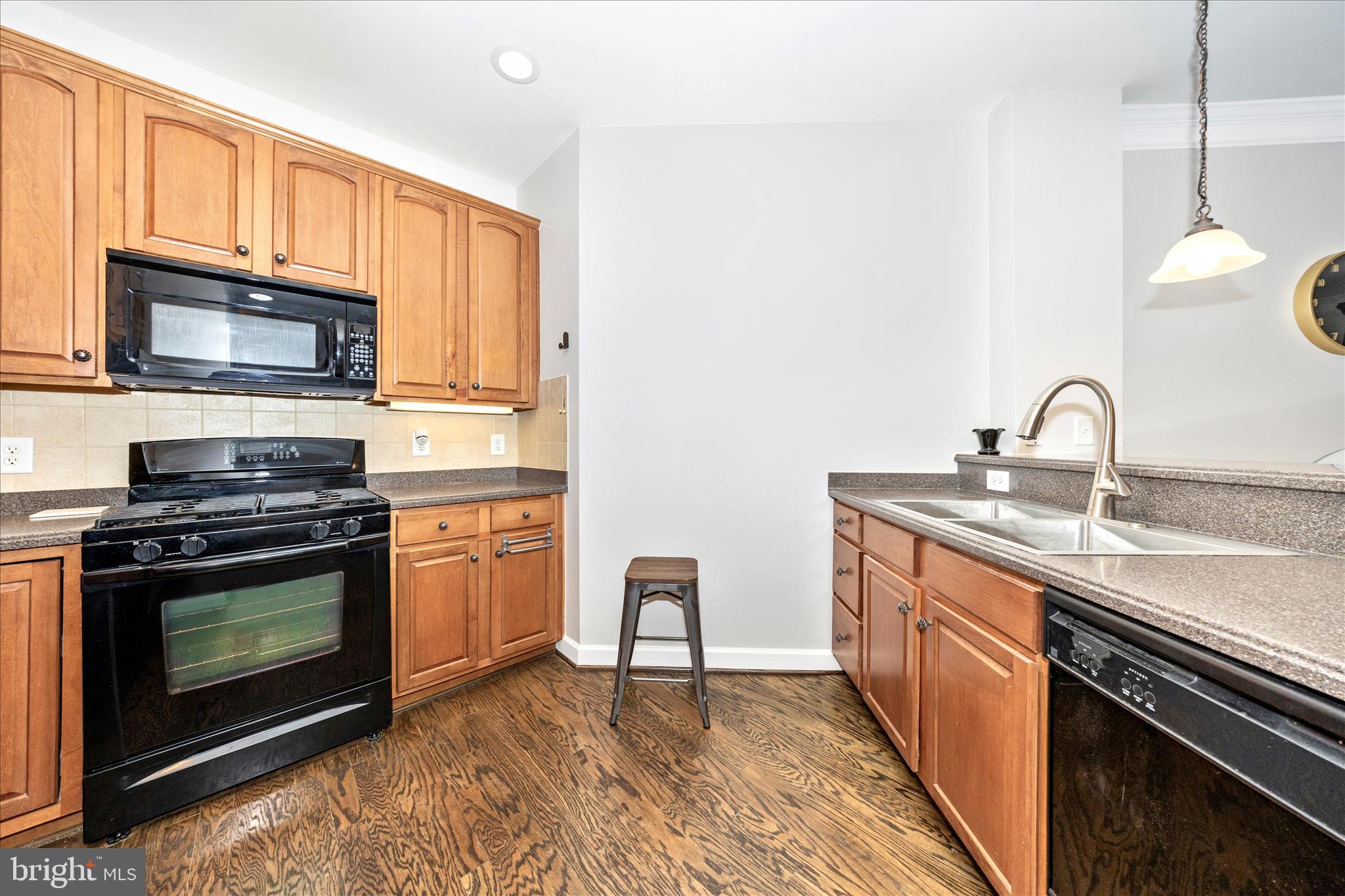 35 East All Saints Street, Unit 114 Frederick, MD 21701 - Photo 16 of 37 a kitchen with stainless steel appliances granite countertop a stove microwave and sink