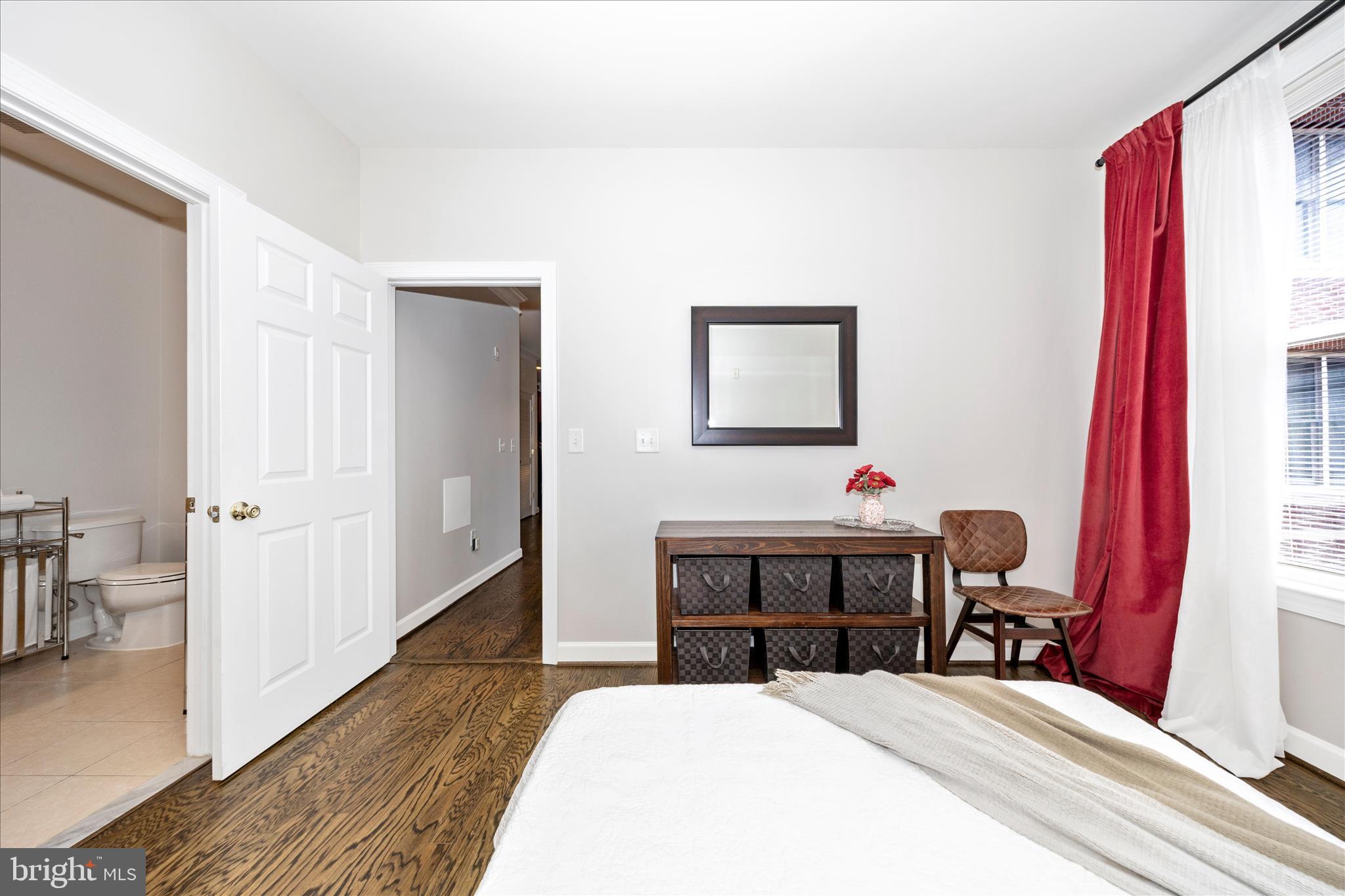 35 East All Saints Street, Unit 114 Frederick, MD 21701 - Photo 19 of 37 a bedroom with a bed and a table in it