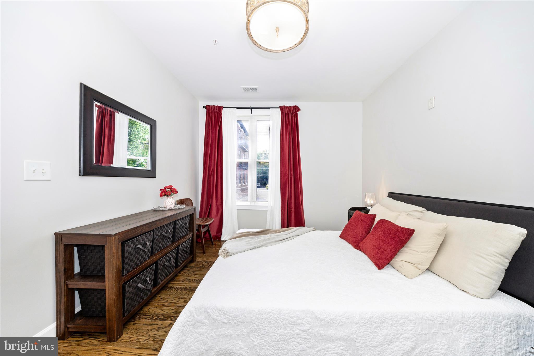 35 East All Saints Street, Unit 114 Frederick, MD 21701 - Photo 21 of 37 a bedroom with a bed and a chandelier