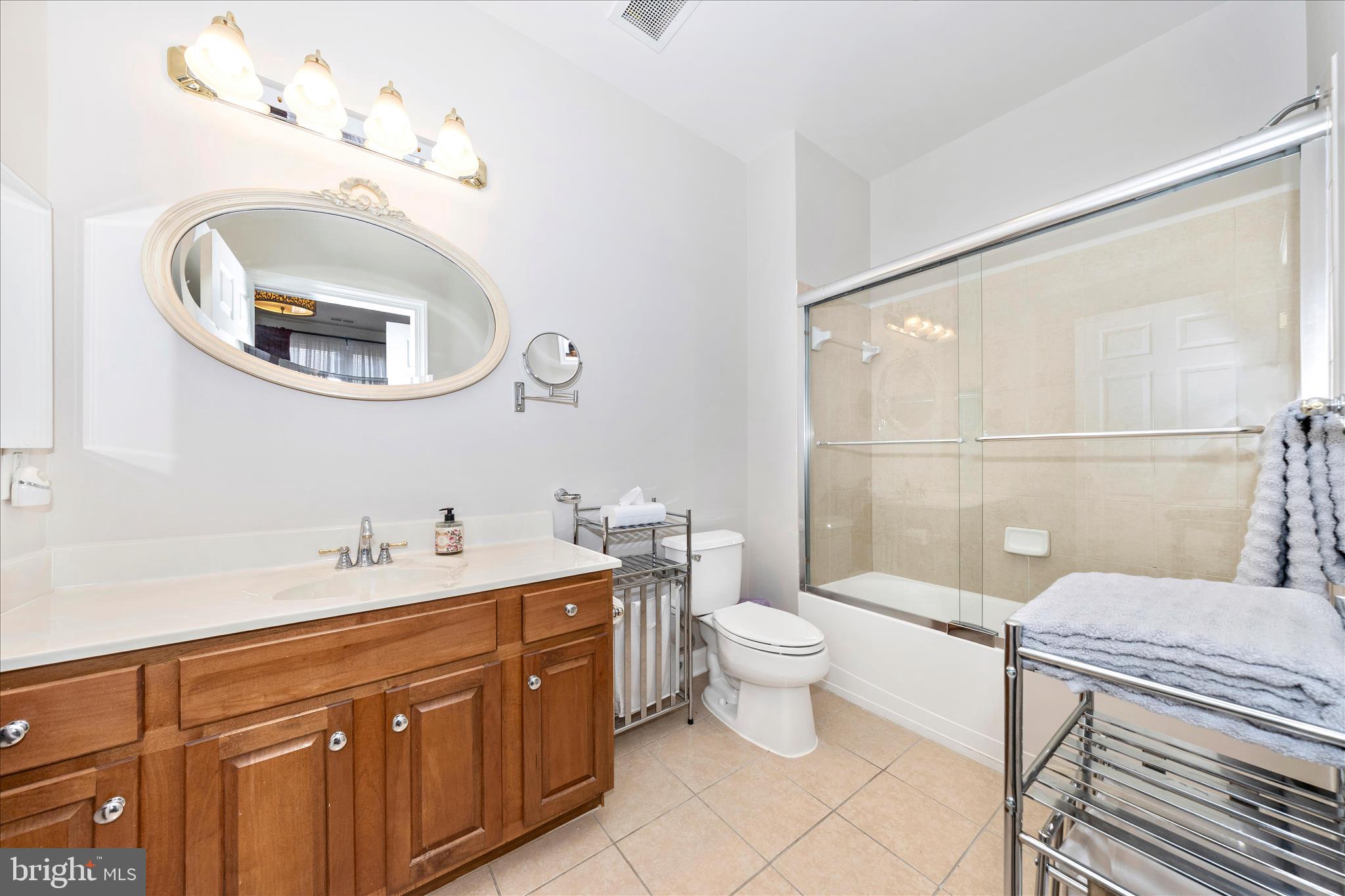 35 East All Saints Street, Unit 114 Frederick, MD 21701 - Photo 22 of 37 a bathroom with a toilet a sink and a mirror