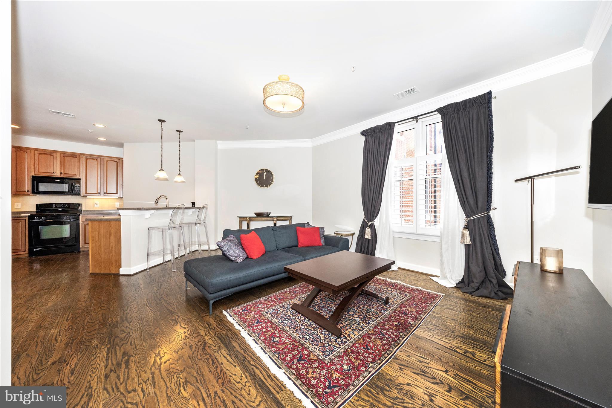 35 East All Saints Street, Unit 114 Frederick, MD 21701 - Photo 6 of 37 a living room with furniture and a wooden floor