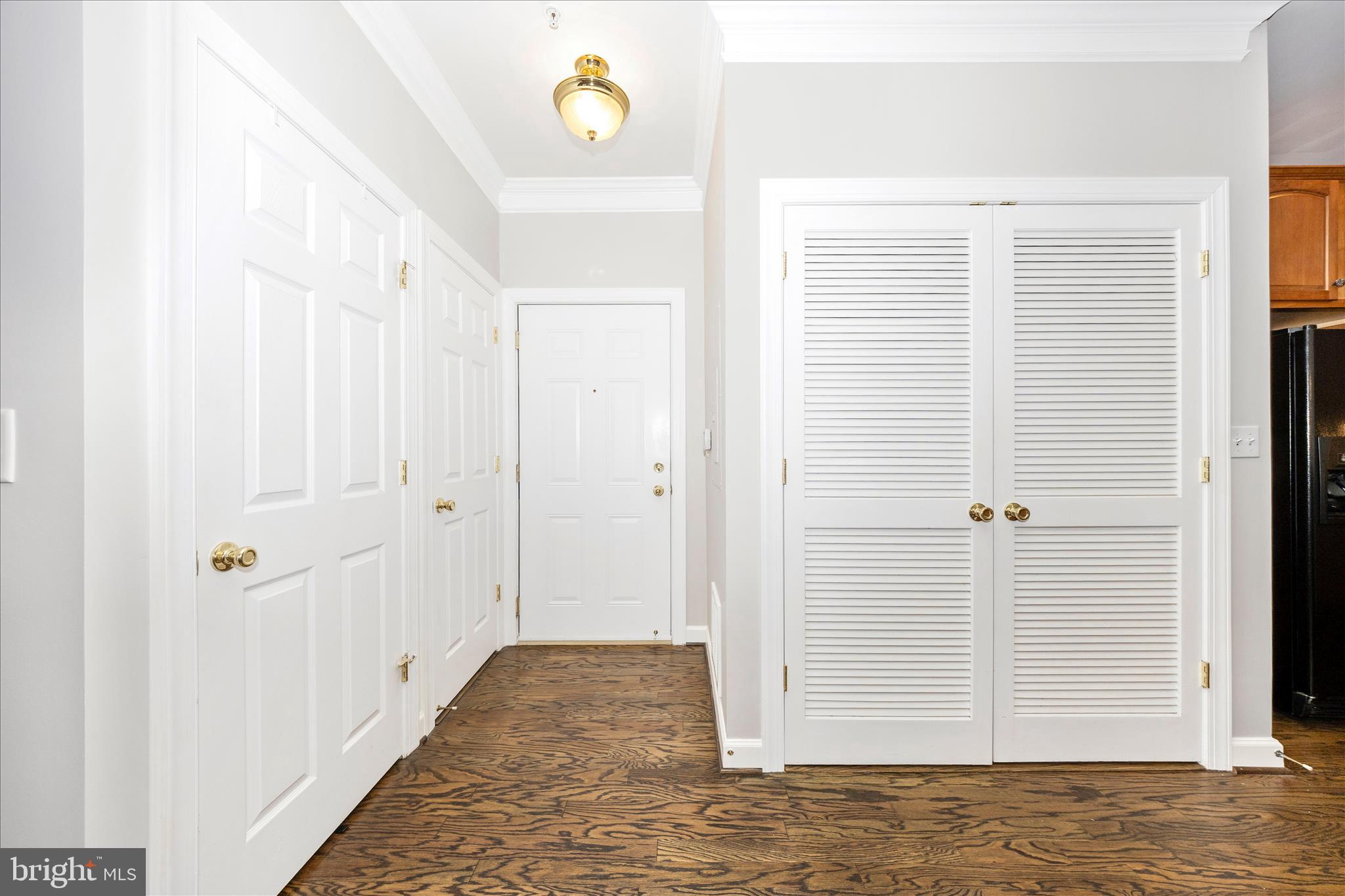35 East All Saints Street, Unit 114 Frederick, MD 21701 - Photo 9 of 37 a view of a hallway with closet and wooden floor