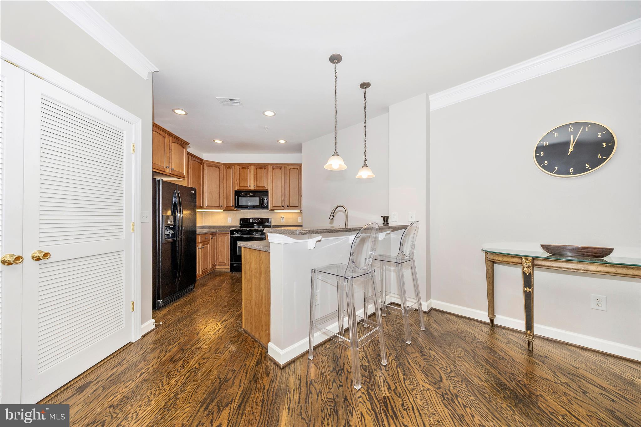 35 East All Saints Street, Unit 114 Frederick, MD 21701 - Photo 10 of 37 a kitchen with white cabinets and stainless steel appliances