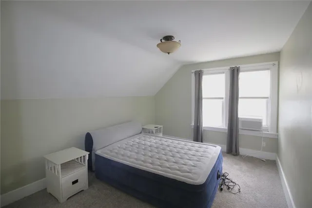 a bedroom with a bed and window