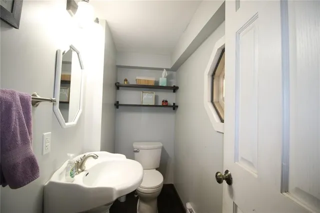 a bathroom with a sink mirror and toilet
