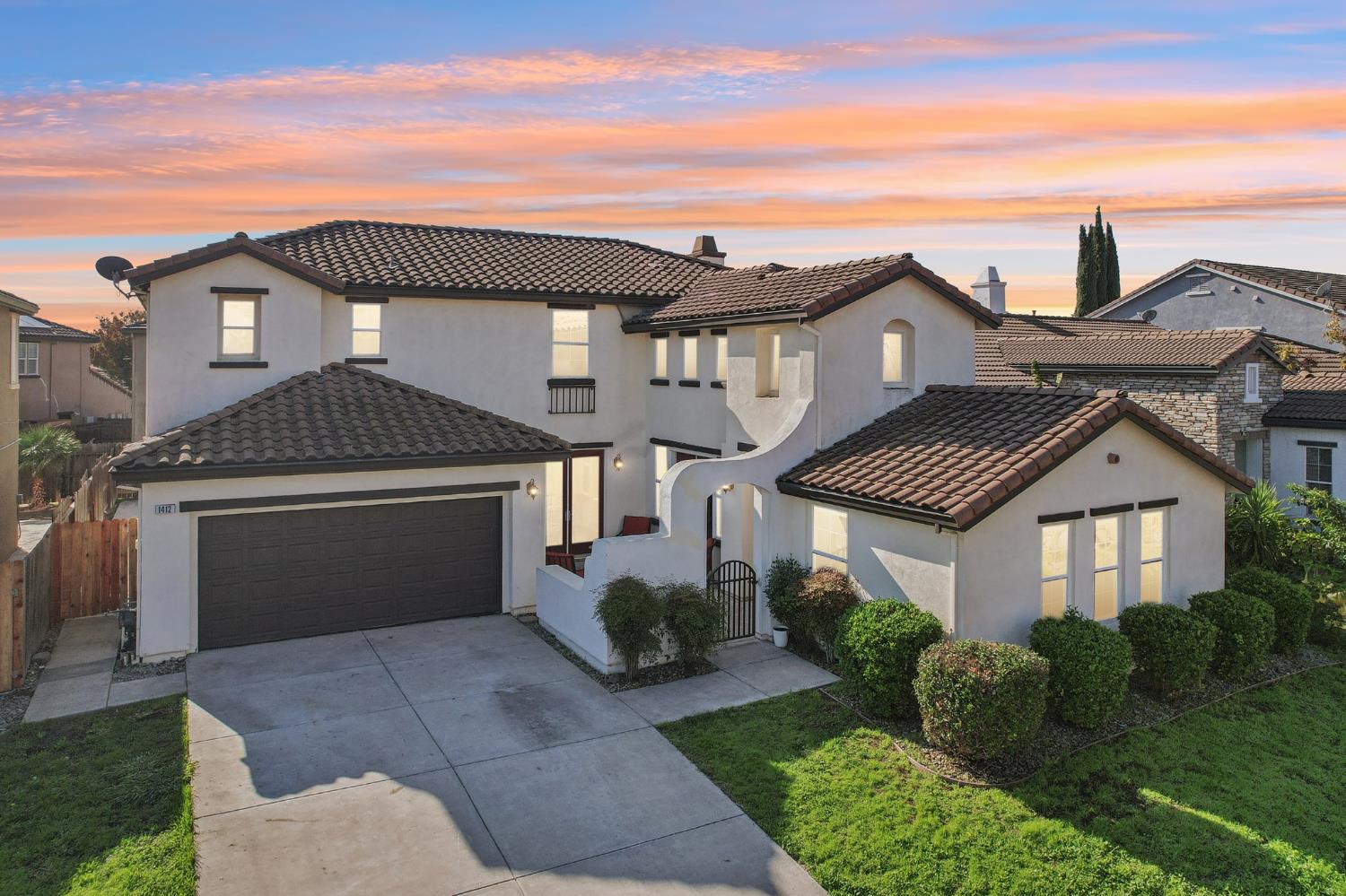 1412 Cliff Swallow Drive Patterson, CA 95363 - Photo 1 of 1 a front view of a house with a garden