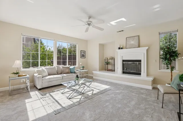a living room with furniture and a fireplace