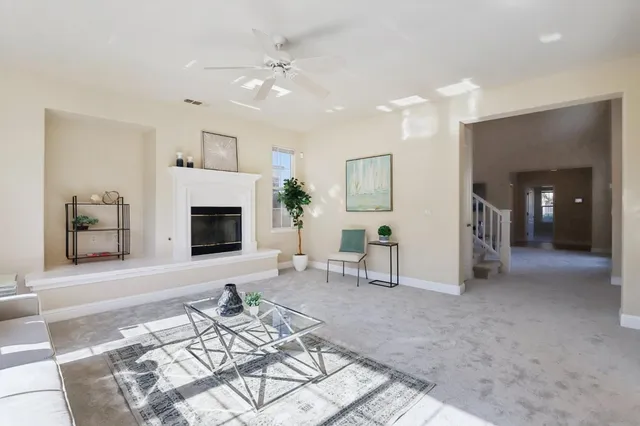 a view of a dining room with furniture and a chandelier