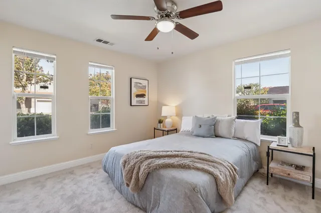 a bedroom with a bed and chair