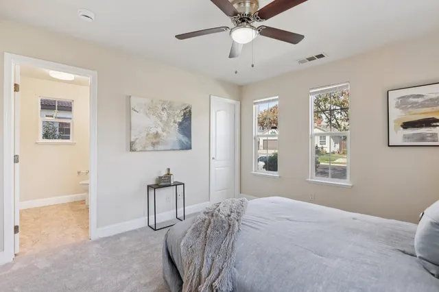 a bathroom with double vanity sinks a toilet and a mirror