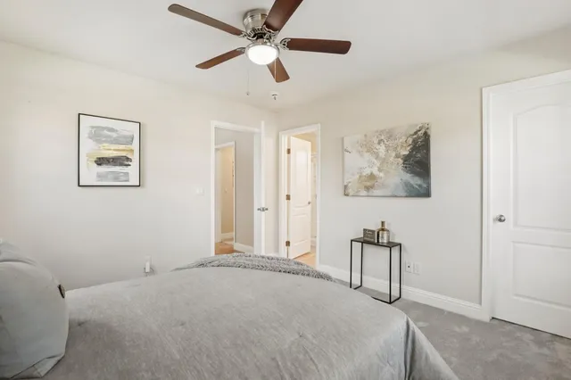 a bedroom with a bed and a potted plant