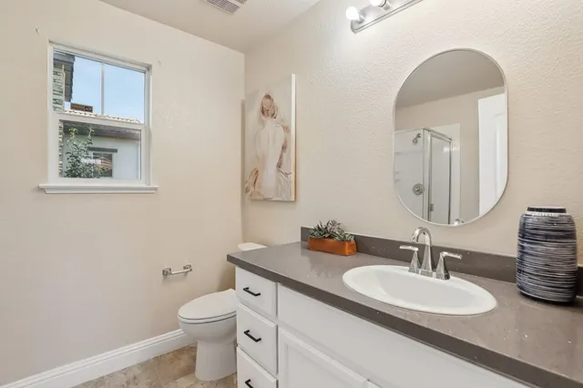 a bedroom with a bed and a potted plant