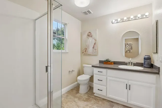a bedroom with a bed and a potted plant