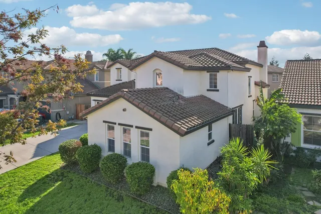 a aerial view of a house next to a yard