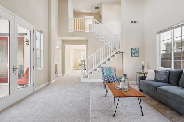 a living room with furniture and a potted plant