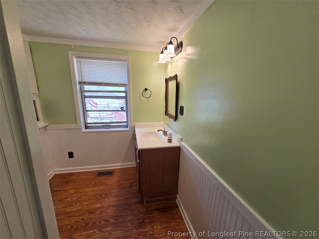 219 East Clinton Street Autryville, NC 28318 - Photo 13 of 32 a bathroom with a sink and mirror with bathtub