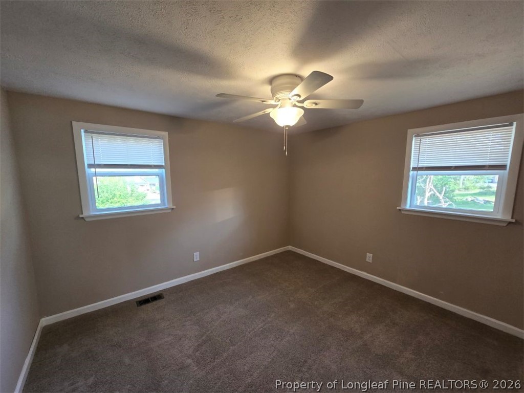 219 East Clinton Street Autryville, NC 28318 - Photo 18 of 32 a view of an empty room with a window