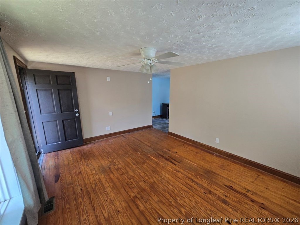 219 East Clinton Street Autryville, NC 28318 - Photo 23 of 32 wooden floor in an empty room with a window