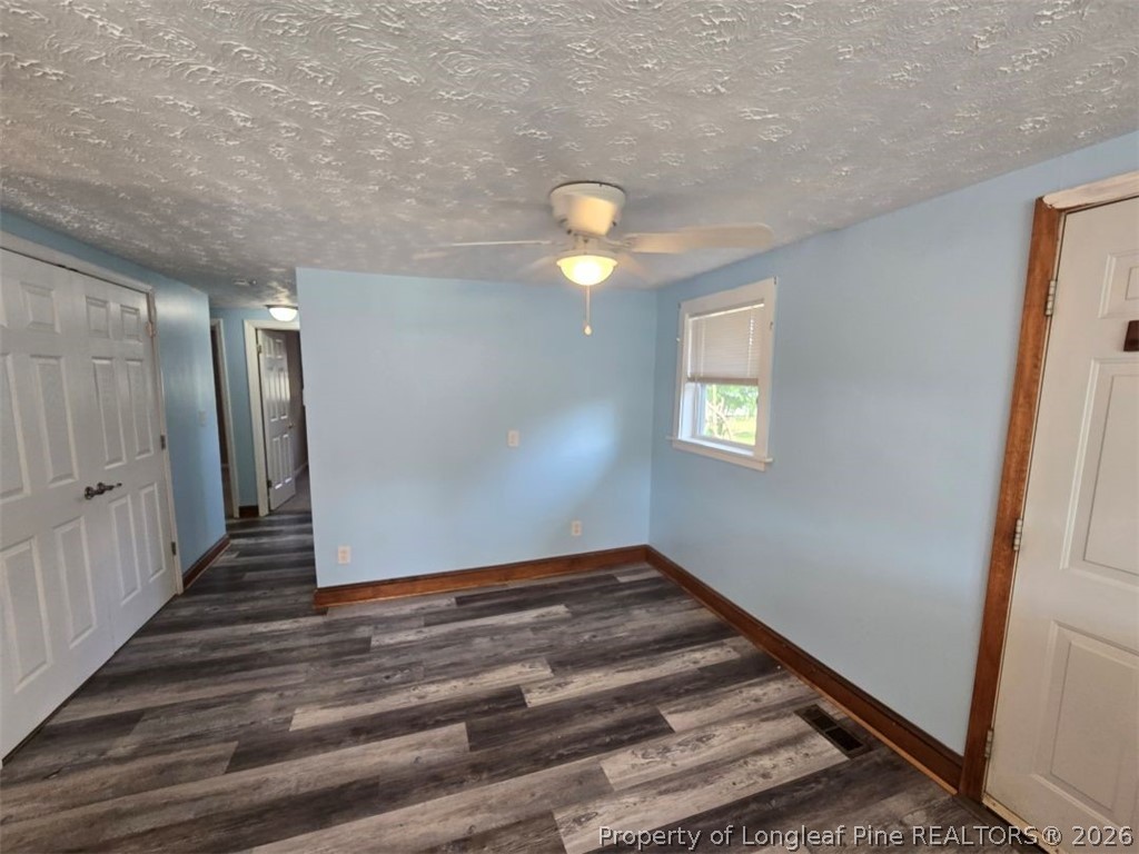 219 East Clinton Street Autryville, NC 28318 - Photo 24 of 32 a view of an empty room with wooden floor and window