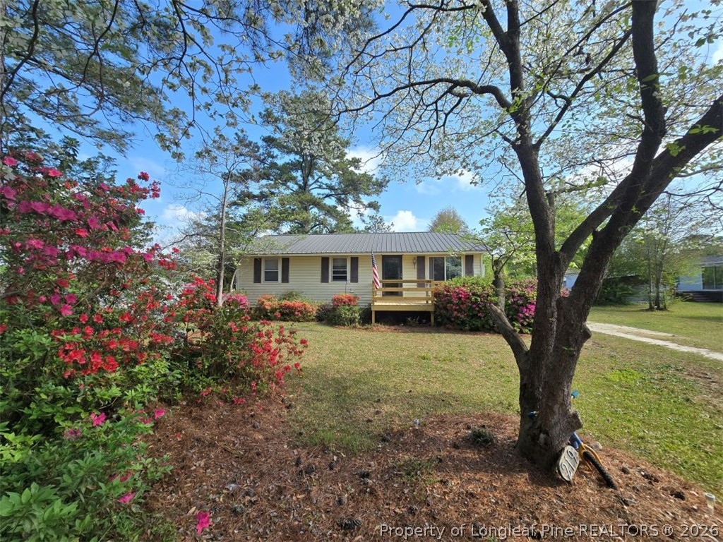 219 East Clinton Street Autryville, NC 28318 - Photo 32 of 32 a front view of a house with garden