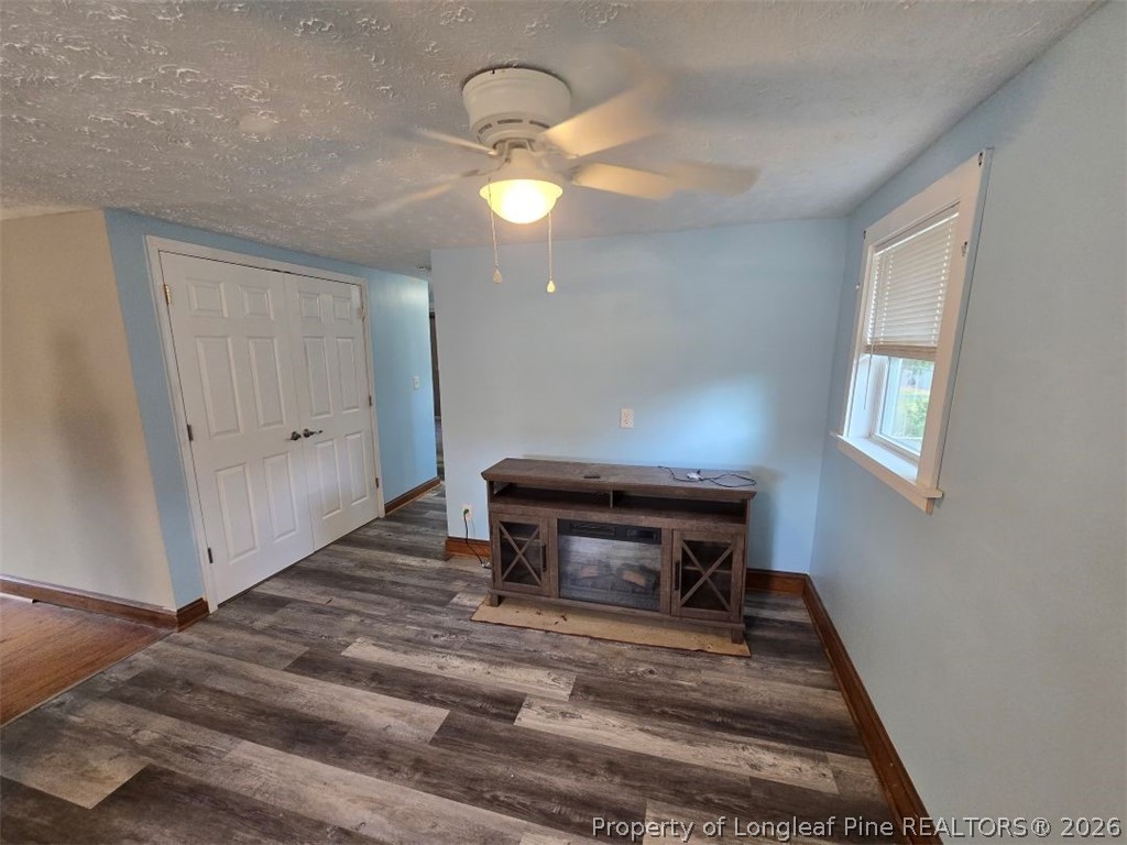 219 East Clinton Street Autryville, NC 28318 - Photo 8 of 32 a bedroom with a bed and a chandelier