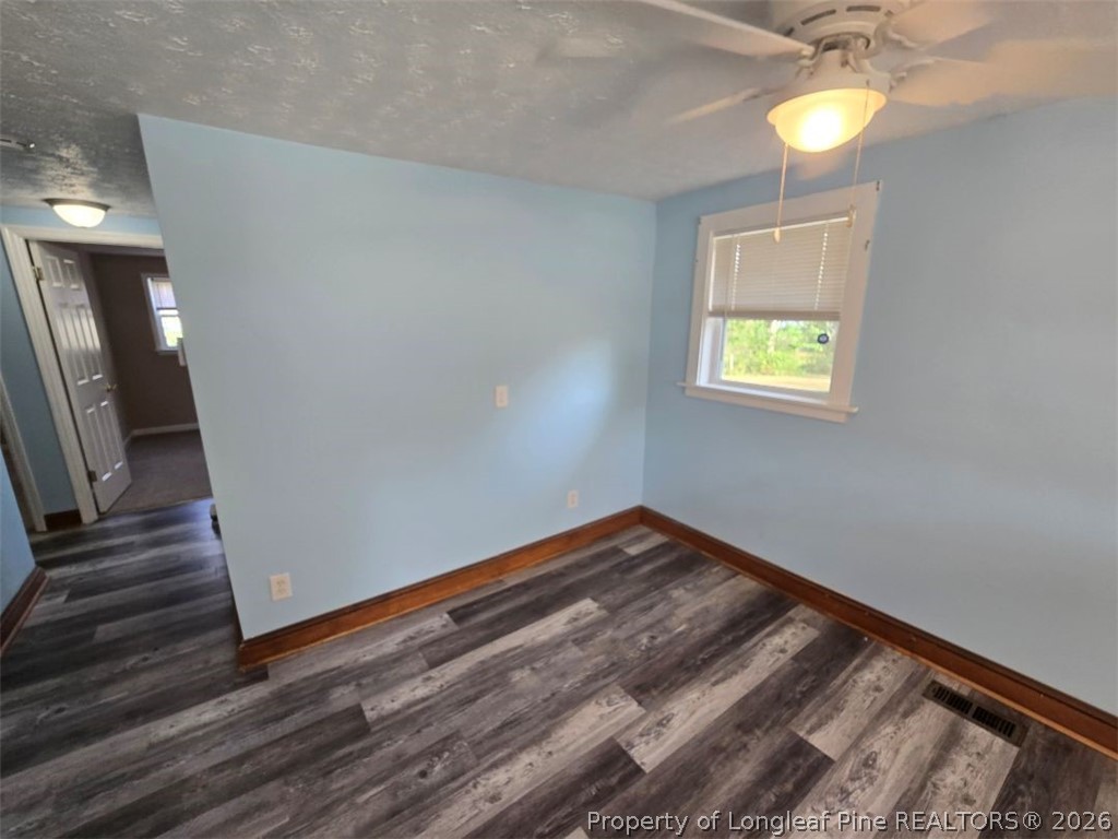 219 East Clinton Street Autryville, NC 28318 - Photo 9 of 32 a view of a room with wooden floor and window