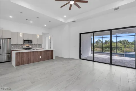 a large kitchen with a large window and stainless steel appliances
