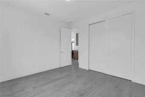 a view of an empty room and wooden floor