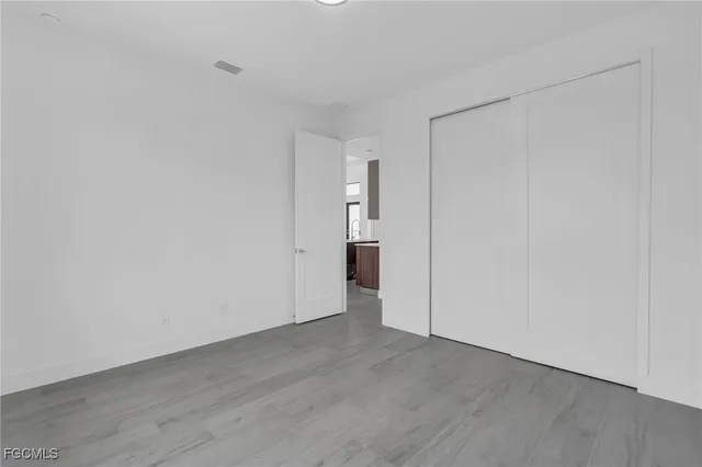 a view of an empty room and wooden floor