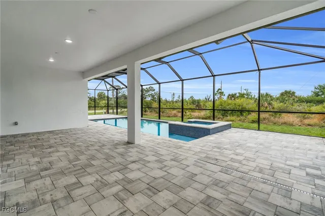 a view of an empty room with a floor to ceiling window and an outdoor view