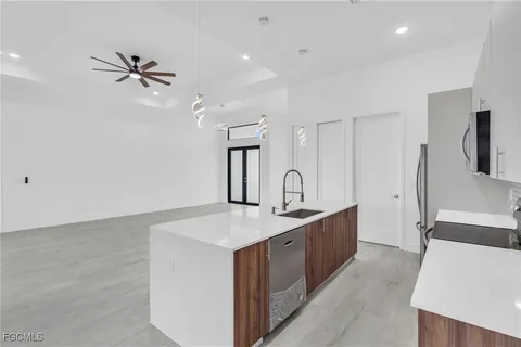 a kitchen with a sink and a refrigerator