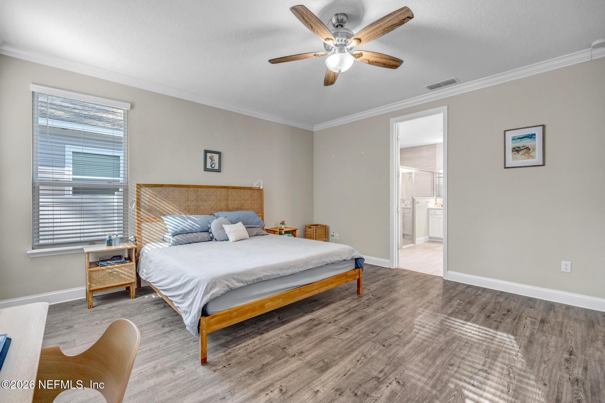 196 Silver Reef Lane St. Augustine, FL 32095 - Photo 24 of 62 a bedroom with a bed and a chandelier